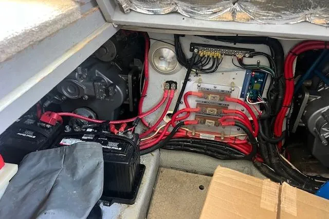 Slide: The Image of Engine compartment of a 1997 Silverton 351 Sedan with visible wiring and batteries. - 20