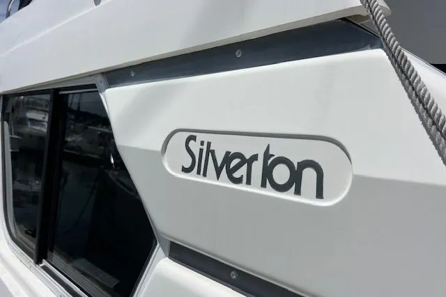 Slide: The Image of 1997 Silverton 351 Sedan Cruiser, close-up of logo on white exterior. - 5