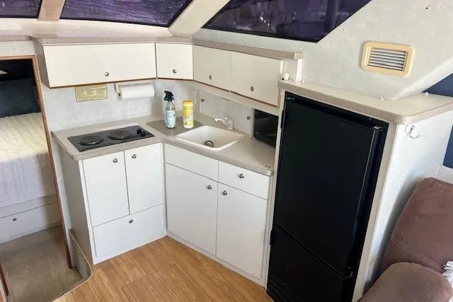 Slide: The Image of 1997 Silverton 351 Sedan yacht kitchen with stove, sink, and refrigerator. - 17
