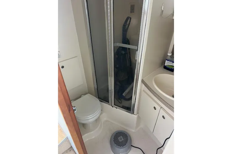 Slide: The Image of 1997 Silverton 351 Sedan bathroom with shower, toilet, and sink. - 19
