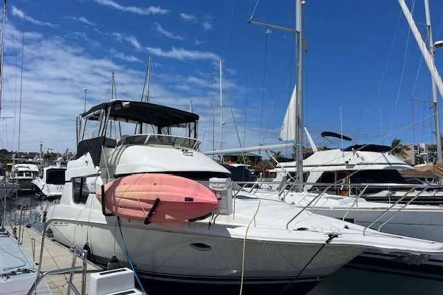 Slide: The Image of 1997 Silverton 351 Sedan Cruiser docked with a pink kayak on deck. - 2