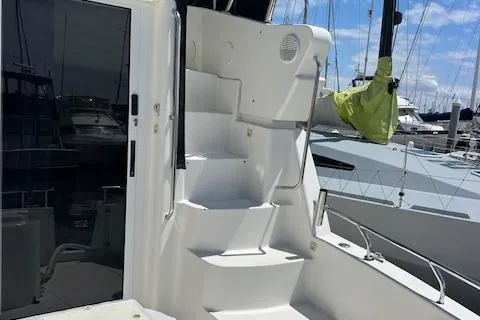 Slide: The Image of 1997 Silverton 351 Sedan Cruiser with white stairs and marina background. - 7