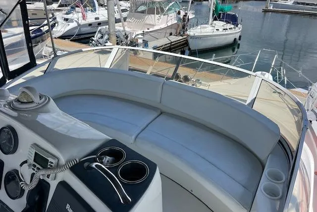 Slide: The Image of 1997 Silverton 351 Sedan Cruiser interior with seating and control panel at marina. - 9