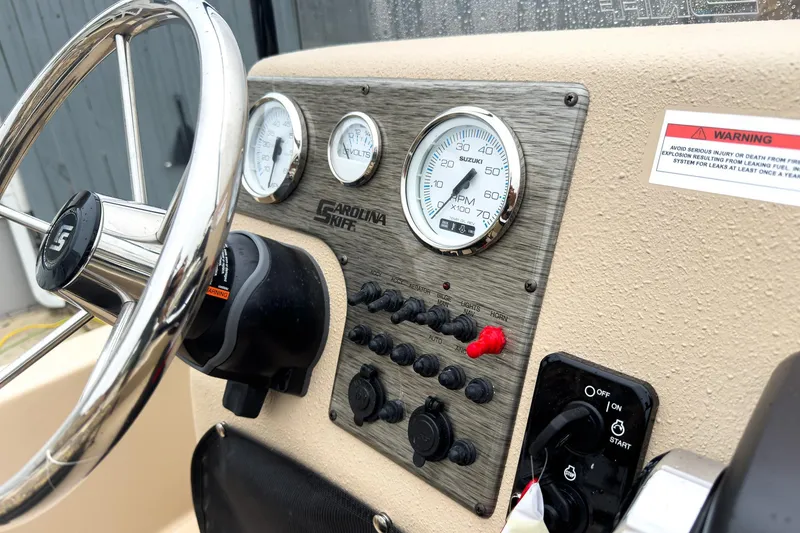 Slide: The Image of 2026 Carolina Skiff E18 JVX CC Sportsman dashboard with steering wheel and gauges. - 11