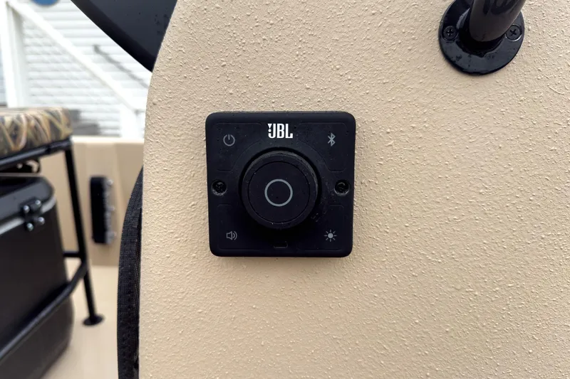 Slide: The Image of JBL control panel on 2026 Carolina Skiff E18 JVX CC Sportsman boat dashboard. - 12