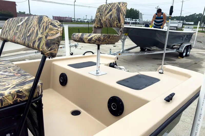 Slide: The Image of 2026 Carolina Skiff E18 JVX CC Sportsman boat with camo seats on display. - 17