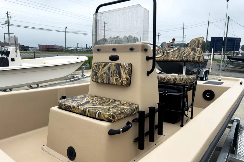 Slide: The Image of 2026 Carolina Skiff E18 JVX CC Sportsman boat with camo seating and center console. - 20