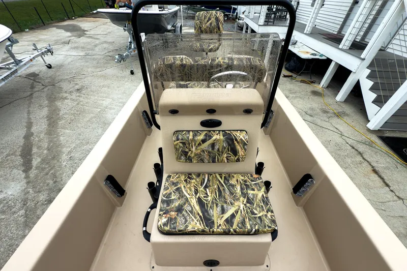 Slide: The Image of 2026 Carolina Skiff E18 JVX CC Sportsman boat interior with camouflage seating and console. - 21