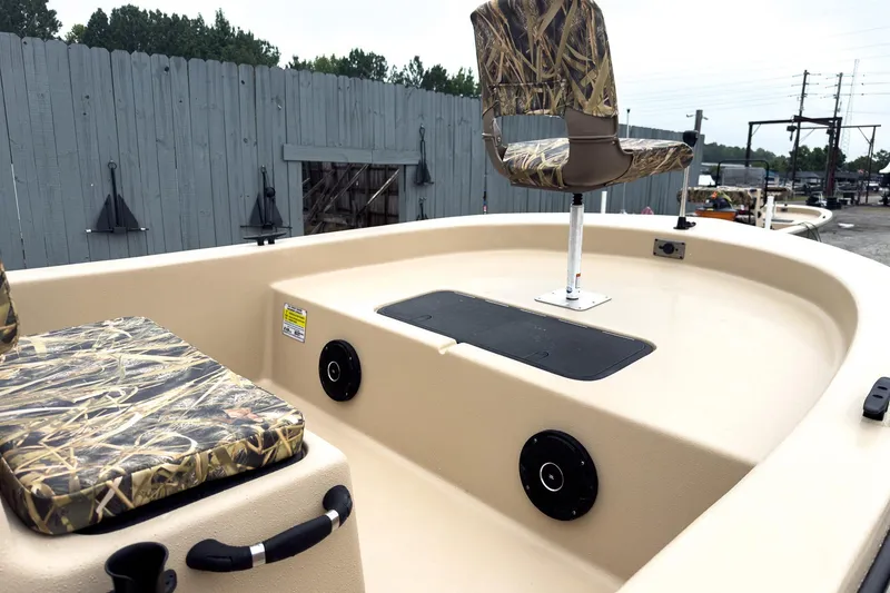 Slide: The Image of 2026 Carolina Skiff E18 JVX CC Sportsman boat with camo seating and spacious deck. - 24