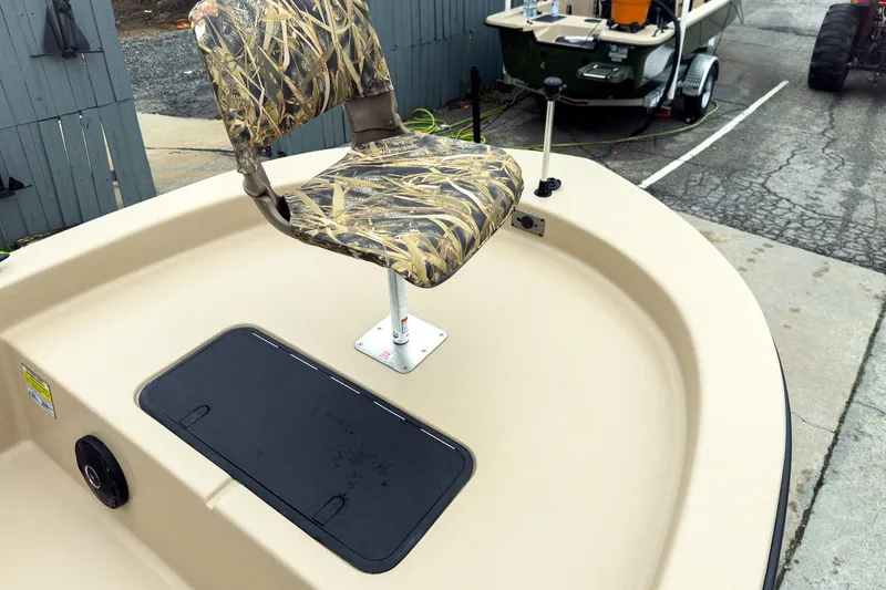 Slide: The Image of 2026 Carolina Skiff E18 JVX CC Sportsman with camo seat and storage hatch. - 25