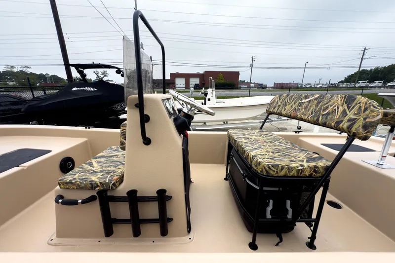 Slide: The Image of 2026 Carolina Skiff E18 JVX CC Sportsman boat interior with camo seating. - 29