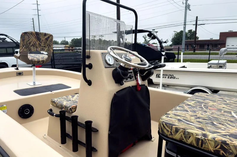 Slide: The Image of 2026 Carolina Skiff E18 JVX CC Sportsman boat with camo seats and steering console. - 31