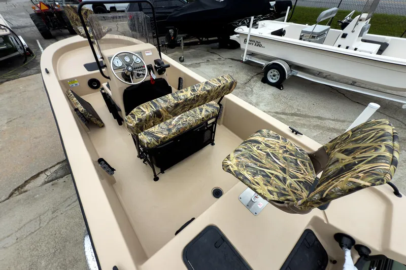 Slide: The Image of 2026 Carolina Skiff E18 JVX CC Sportsman boat with camo seats and steering console. - 6