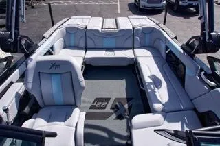 Slide: The Image of 2025 MasterCraft XT22 T boat interior with luxurious seating and modern design. - 12