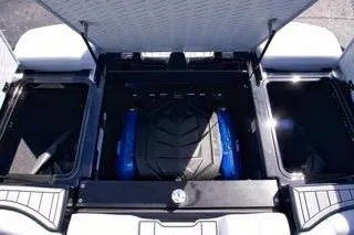 Slide: The Image of 2025 MasterCraft XT22 T boat engine compartment with open hatch, showcasing modern design. - 14