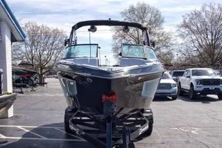 Slide: The Image of 2025 MasterCraft XT22 T boat on trailer in parking lot, front view. - 5