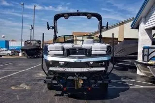 Slide: The Image of 2025 MasterCraft XT22 T boat in a dealership parking lot, rear view. - 6