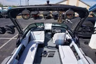Slide: The Image of 2025 MasterCraft XT22 T boat interior with seating and speakers, displayed outdoors. - 8