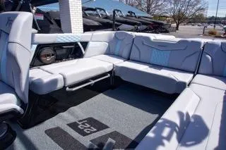 Slide: The Image of 2025 MasterCraft XT22 T boat interior with luxurious seating and modern design. - 9