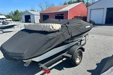 Slide: The Image of Covered 2015 Scarab 165 boat on trailer in outdoor storage area. - 3