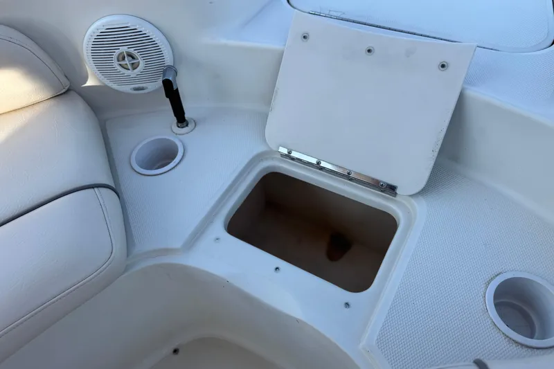 Slide: The Image of Interior of 2000 Sea Ray 240 Sundeck showing storage compartment and speaker. - 13