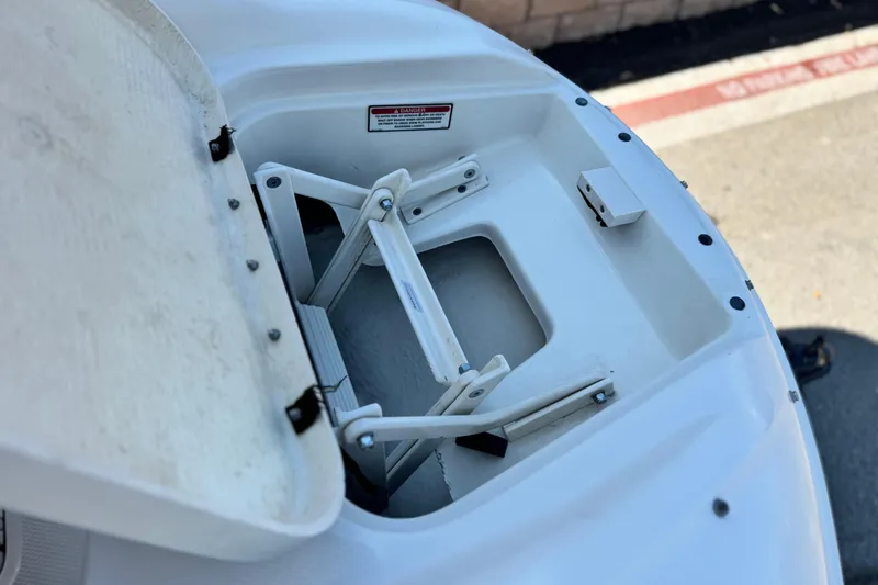 Slide: The Image of Open storage compartment on a 2000 Sea Ray 240 Sundeck boat. - 15