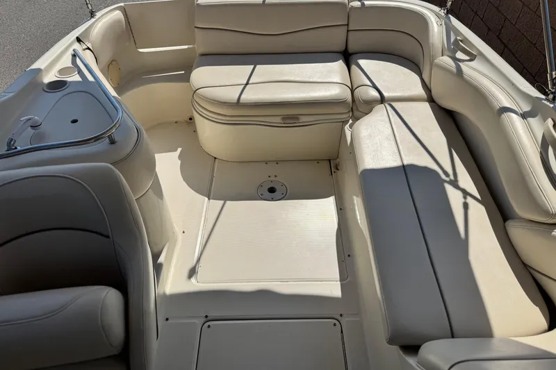 Slide: The Image of 2000 Sea Ray 240 Sundeck interior with beige seating and built-in amenities. - 17