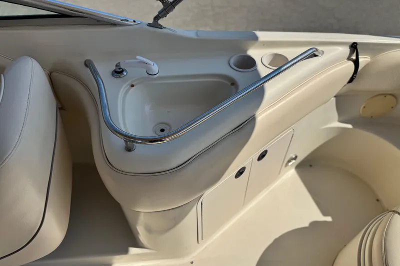 Slide: The Image of Interior of a 2000 Sea Ray 240 Sundeck boat featuring a sink and storage area. - 18