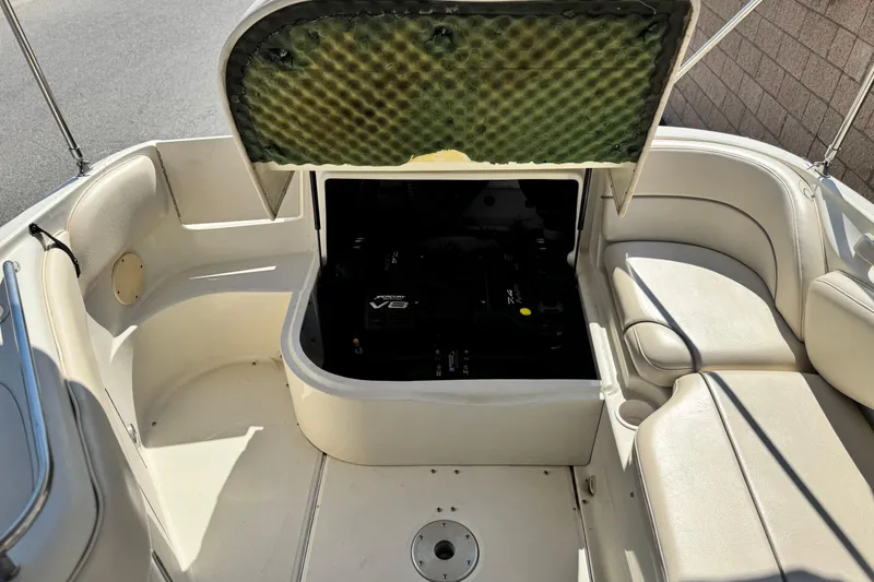 Slide: The Image of 2000 Sea Ray 240 Sundeck engine compartment with open hatch, revealing V8 engine. - 20