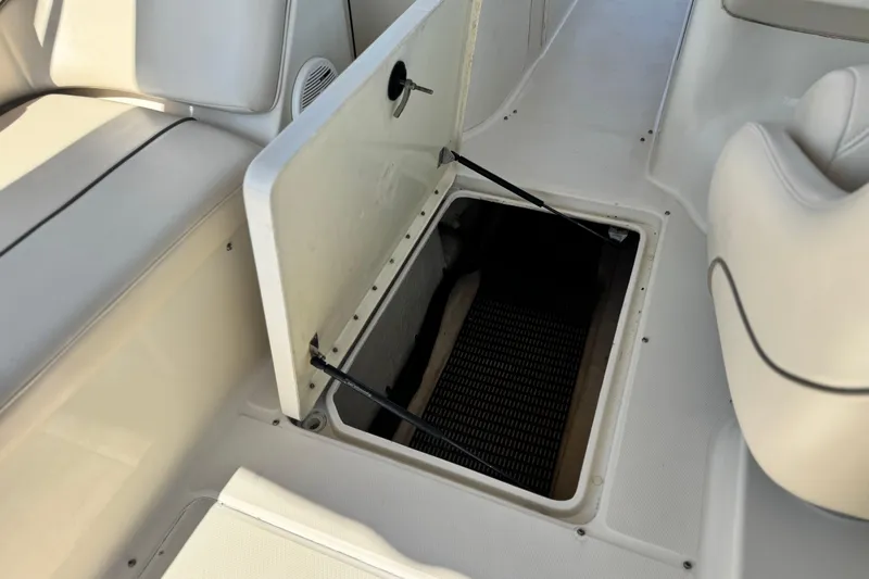 Slide: The Image of Open storage compartment on 2000 Sea Ray 240 Sundeck boat interior. - 22