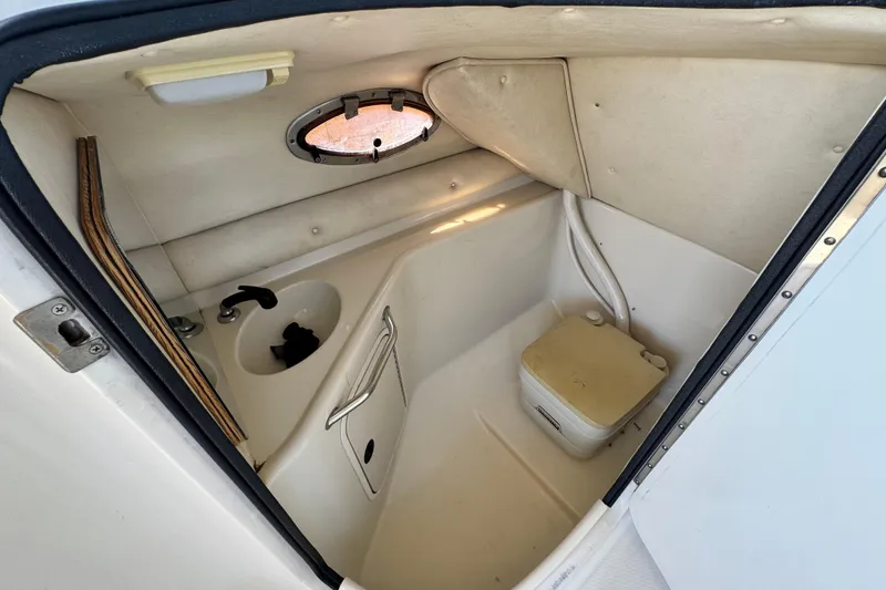 Slide: The Image of Interior of 2000 Sea Ray 240 Sundeck boat with compact bathroom amenities. - 24