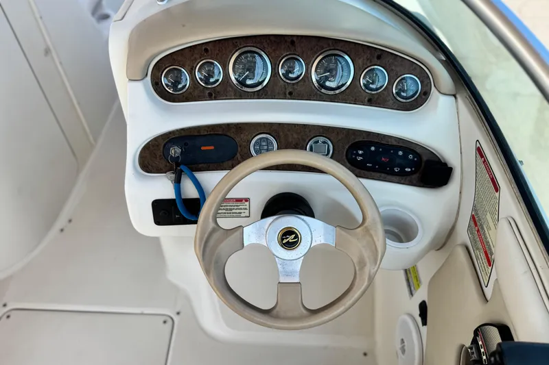 Slide: The Image of Steering console of a 2000 Sea Ray 240 Sundeck boat with gauges and controls. - 26