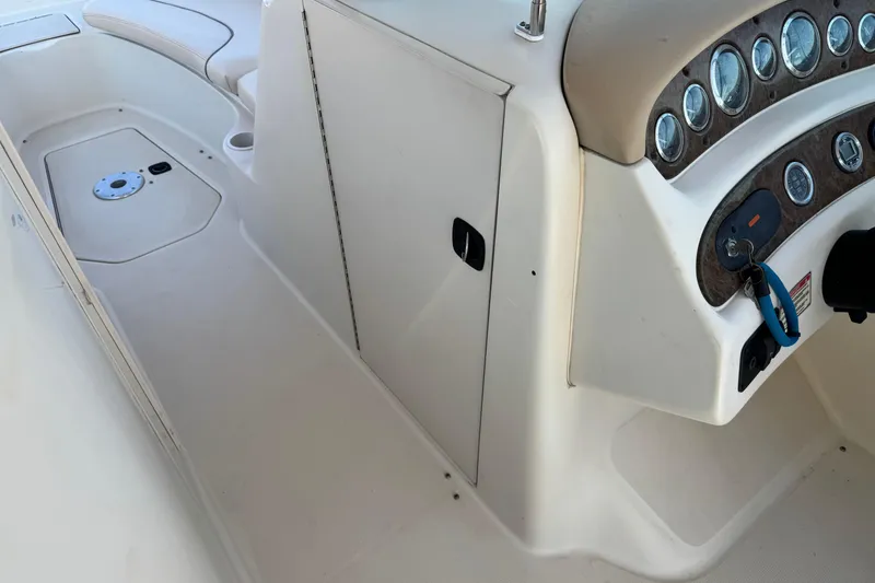 Slide: The Image of 2000 Sea Ray 240 Sundeck interior with dashboard and seating area. - 28