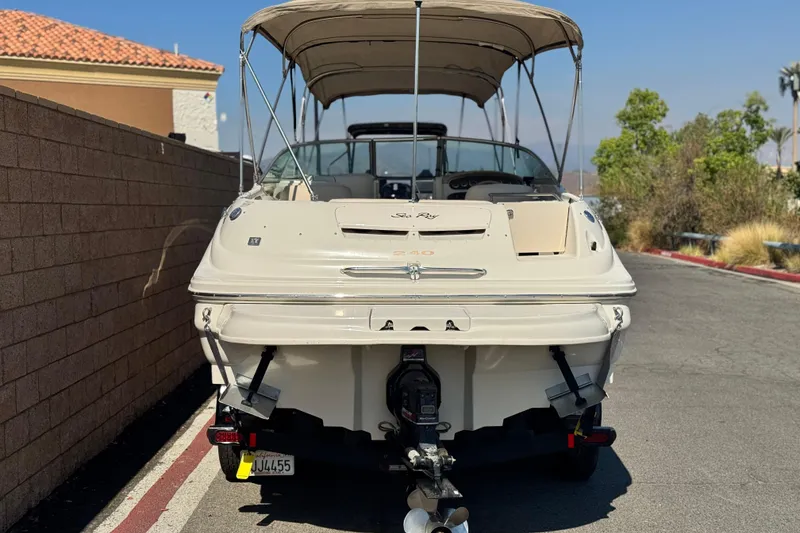Slide: The Image of 2000 Sea Ray 240 Sundeck boat parked on a street, rear view. - 4