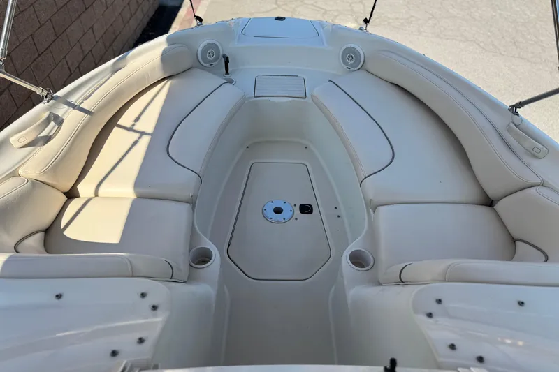 Slide: The Image of 2000 Sea Ray 240 Sundeck boat interior with white cushioned seating. - 9