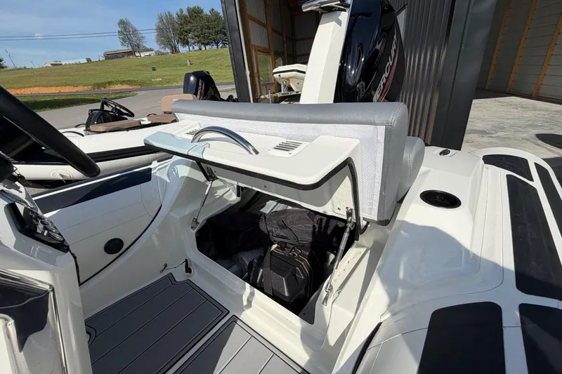 Slide: The Image of 2026 Brig Eagle 4 boat interior with open storage compartment and visible Mercury engine. - 6