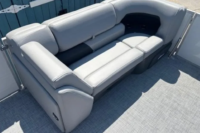 Slide: The Image of 2025 Sun Tracker Party Barge 20 DLX, featuring luxurious gray seating on deck. - 13