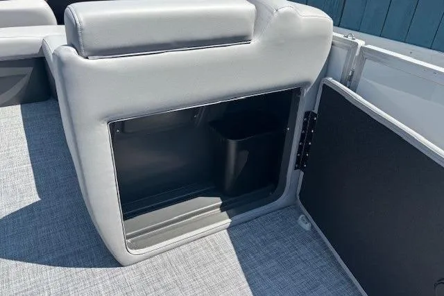 Slide: The Image of 2025 Sun Tracker Party Barge 20 DLX interior storage compartment with gray upholstery. - 19