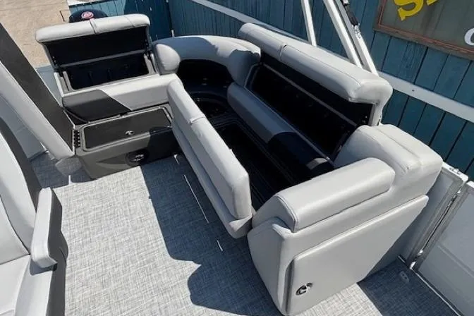 Slide: The Image of 2025 Sun Tracker Party Barge 20 DLX interior with gray seating and storage compartments. - 21