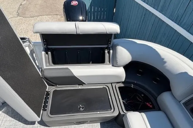 Slide: The Image of 2025 Sun Tracker Party Barge 20 DLX interior with storage compartments and seating. - 22