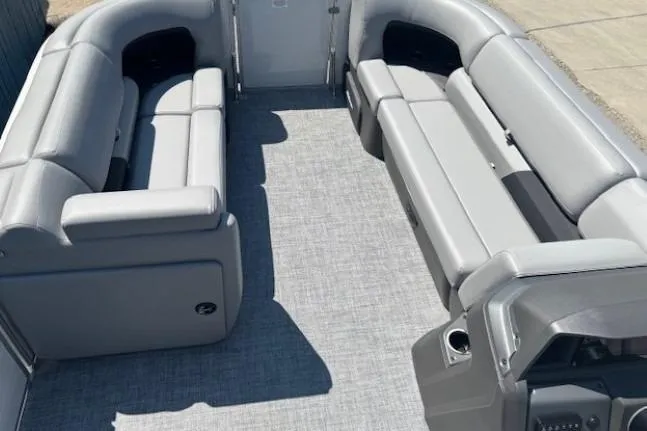 Slide: The Image of 2025 Sun Tracker Party Barge 20 DLX interior with gray seating and flooring. - 9