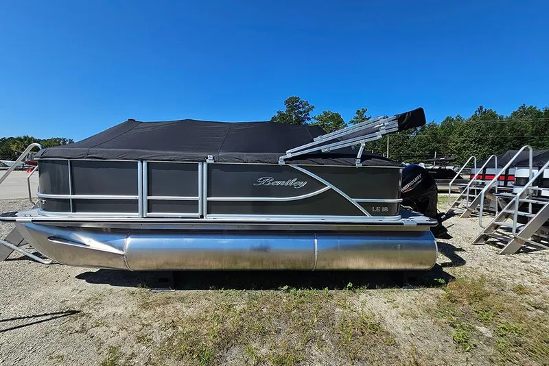 The Image of 2026 Bentley Pontoons LE 180 Cruise pontoon boat with black cover, parked outdoors. - 0