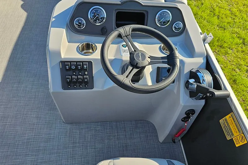 Slide: The Image of 2026 Bentley Pontoons LE 180 Cruise helm with steering wheel and captain's chair. - 16