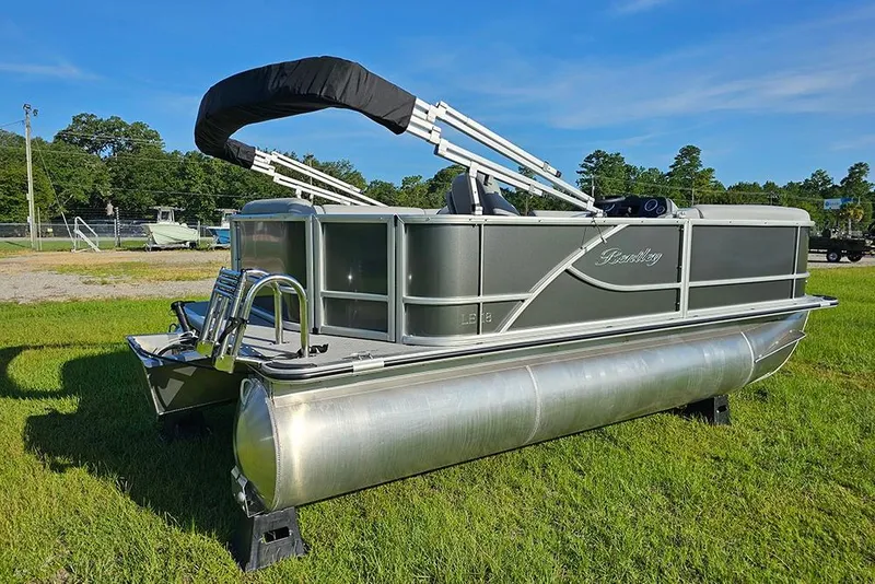 Slide: The Image of 2026 Bentley Pontoons LE 180 Cruise pontoon boat on grassy field, side view. - 3