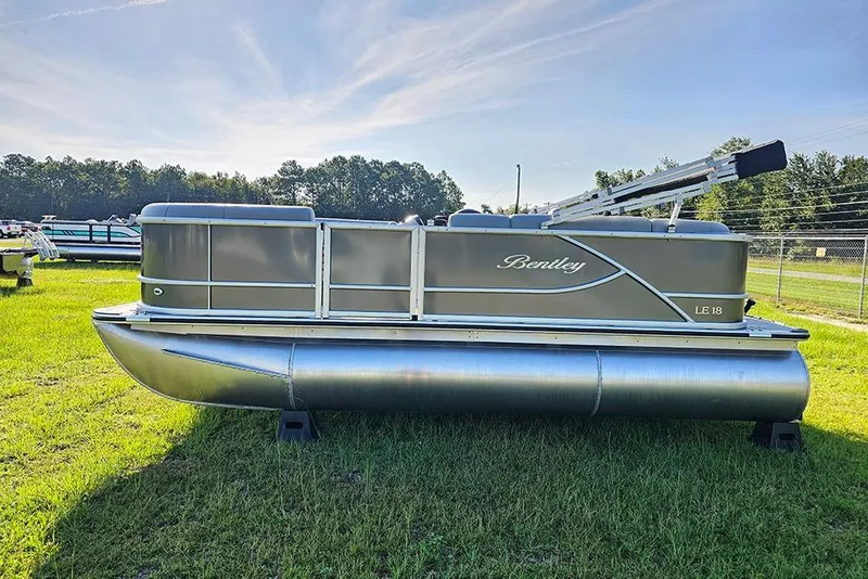 Slide: The Image of 2026 Bentley Pontoons LE 180 Cruise on grass, showcasing sleek design and luxury features. - 6