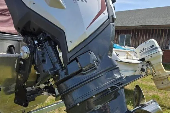 Slide: The Image of 2019 Manitou Legacy 25 RFXW pontoon boat with luxurious seating and red accents. - 10