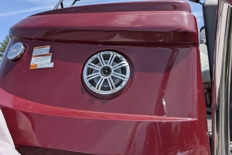 Slide: The Image of 2019 Manitou Legacy 25 RFXW boat with speaker and warning labels on red panel. - 16