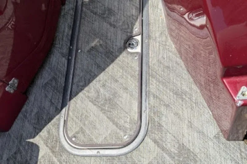 Slide: The Image of 2019 Manitou Legacy 25 RFXW boat floor with red accents and hatch. - 21