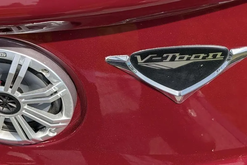 Slide: The Image of Close-up of 2019 Manitou Legacy 25 RFXW V-Toon logo and speaker on red surface. - 25