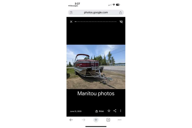 Slide: The Image of 2019 Manitou Legacy 25 RFXW pontoon boat on trailer, parked outdoors. - 29